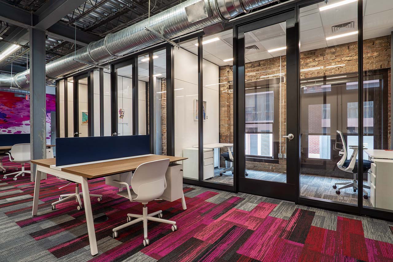 A view showcasing both a private office and a hot desk.